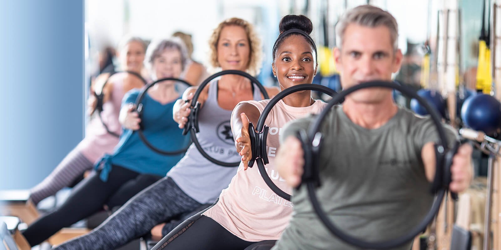 Group exercising in a Club Pilates class